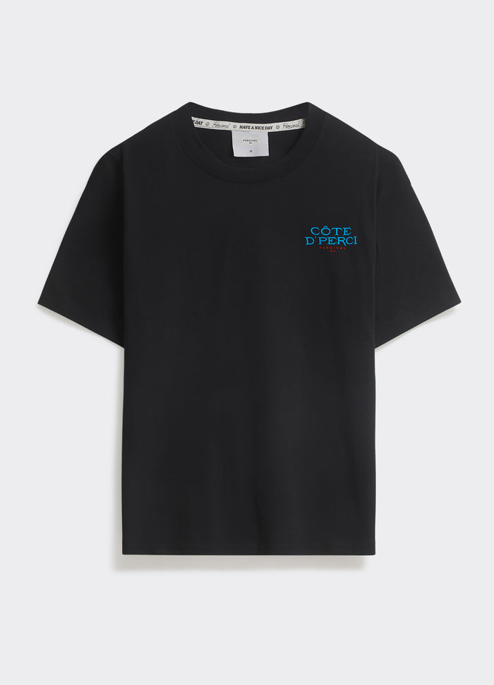 The Percival Azur T-shirt in black cotton jersey, featuring a blue Côte d’Perci chest logo, shown flat on a grey background.