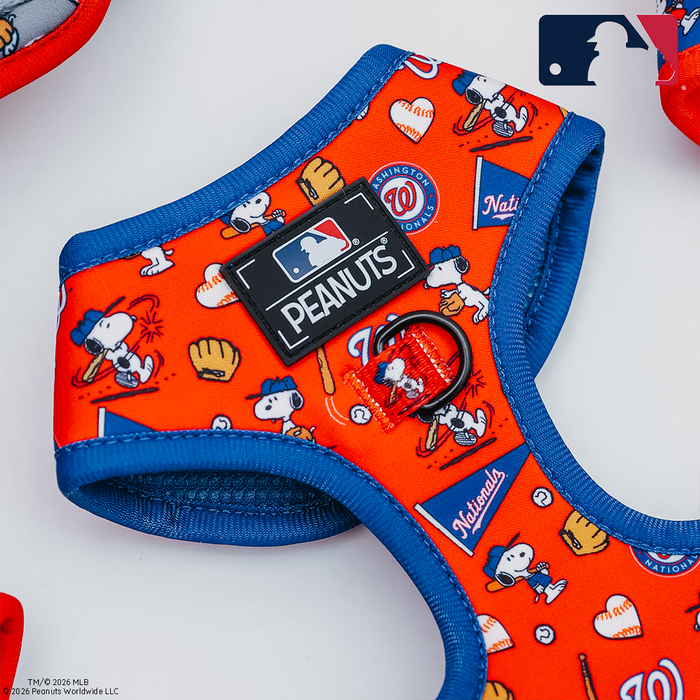 The Sassy Woof Dog Adjustable Harness - MLB™ x Peanuts™ Washington Nationals™ features official team branding, playful Snoopy illustrations, and bold red and blue colors—perfect for Nationals fans seeking a fun, stylish harness for their dog.