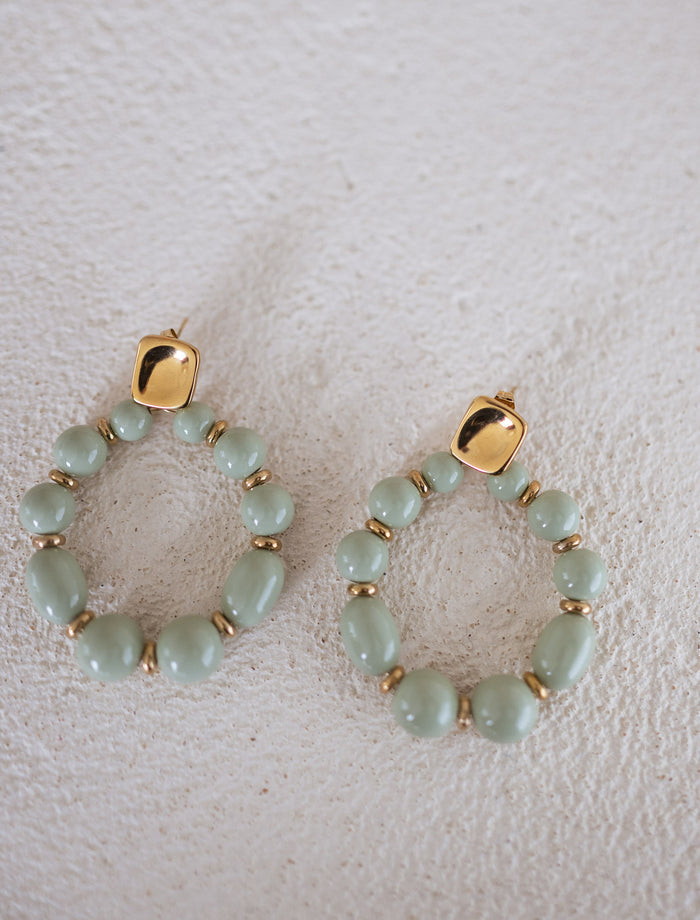 Golden and green Loda beaded hoop earrings detail