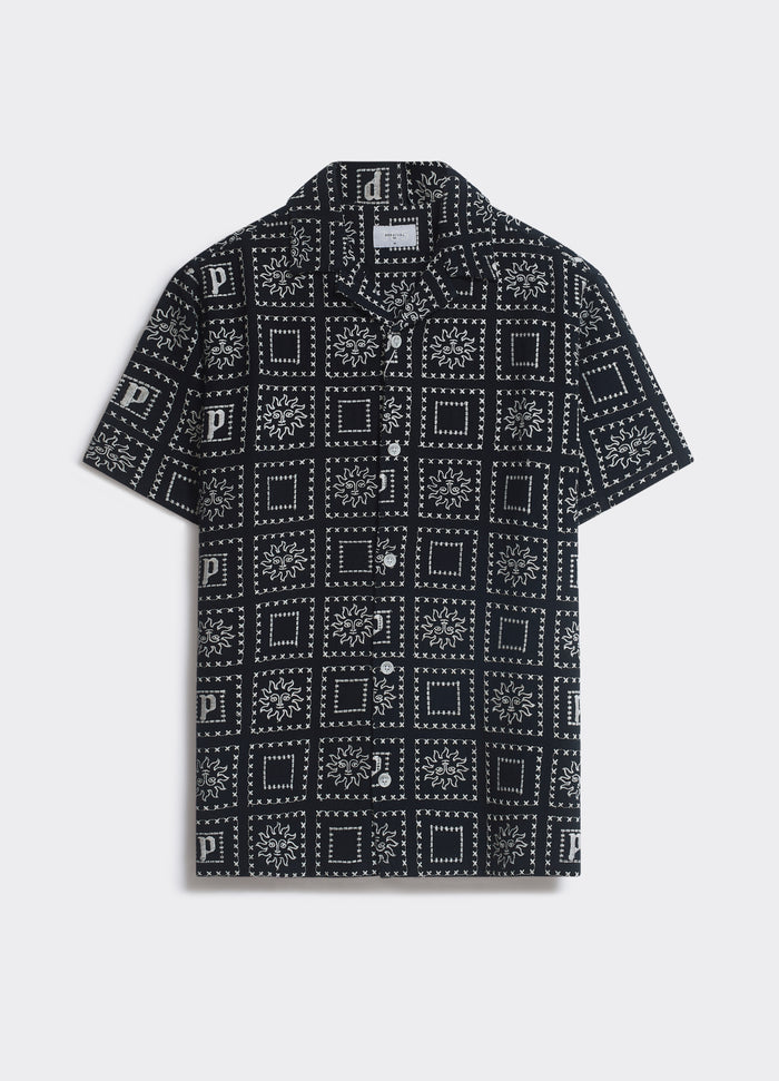 The black Percival Heaton Shirt with an all-over sun motif, featuring a camp collar and short sleeves, shown flat.