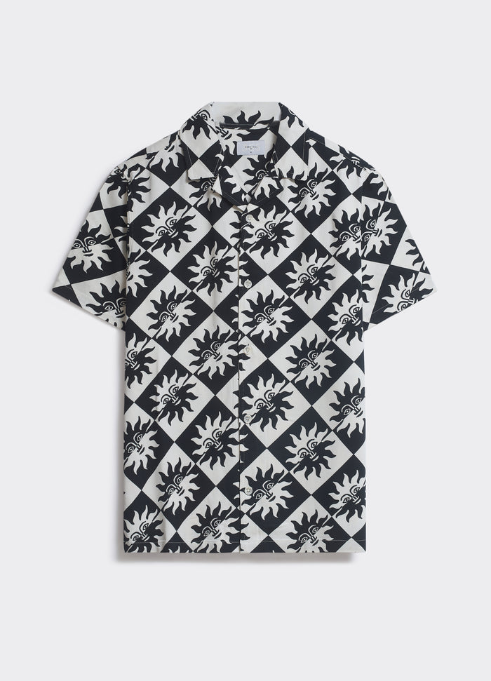 The Percival Hot Shirt in black and off-white with a sun motif and diamond check print, featuring a camp collar, shown flat.