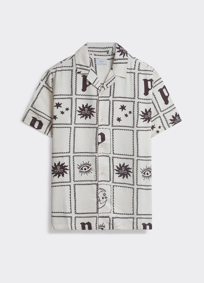 The Percival Panels Shirt in cream and brown, a camp collar style with an all-over tiled celestial print, shown flat.