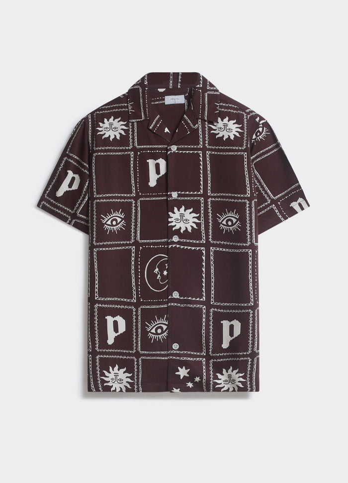 The Percival Panels Shirt in wine, featuring ecru iconography and a camp collar, shown flat against a white background.