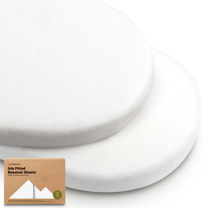 Two plain white oval bassinet fitted sheets stacked together with product packaging.