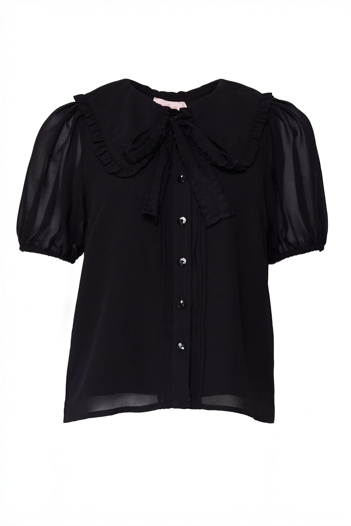 Black blouse with ruffled collar and puff sleeves on a white background with a tie under the collar