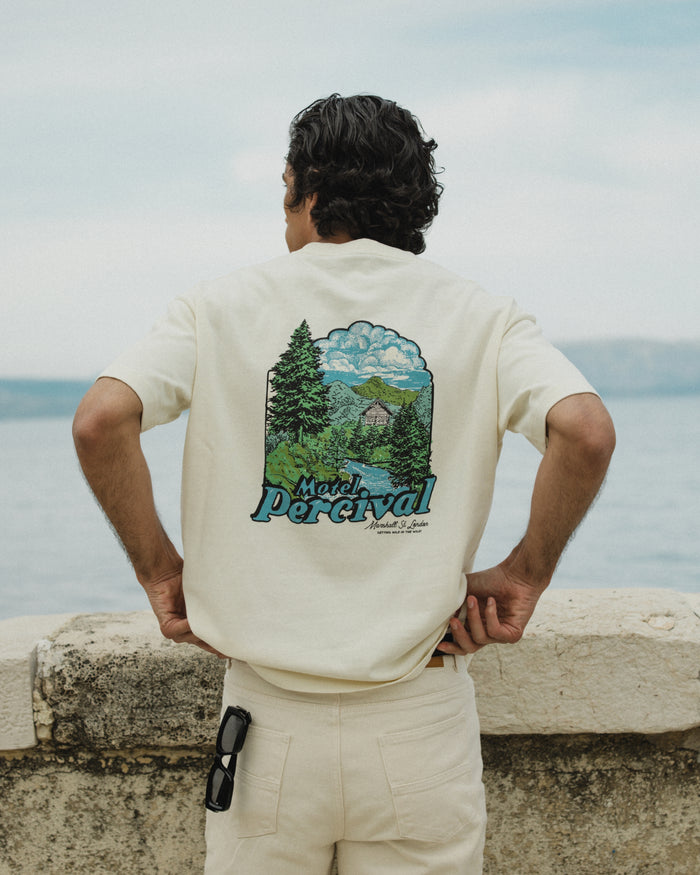 Rear view of the Percival Arnold Oversized T-Shirt in cream, highlighting the large Motel Percival scenic back graphic.