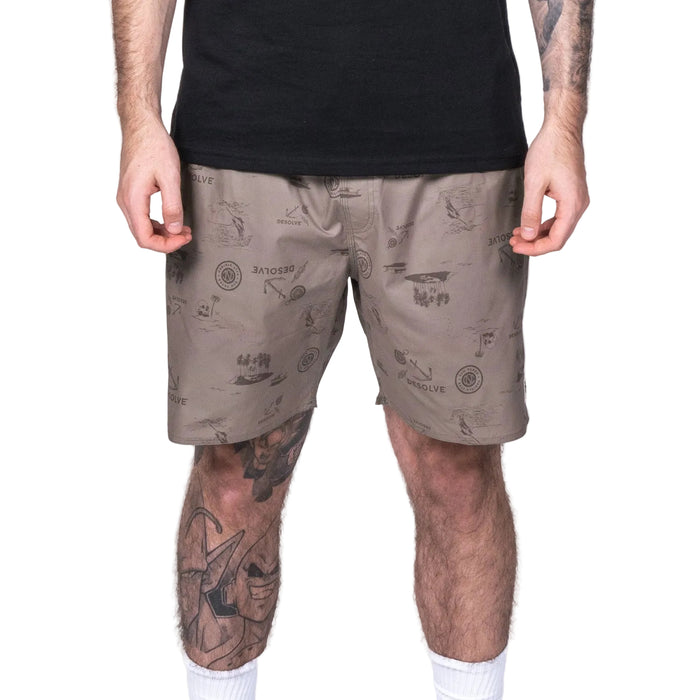 A pair of beige, patterned shorts with a full elastic waistband and drawstring, shown from the waist to the knees on a model wearing a black T-shirt.