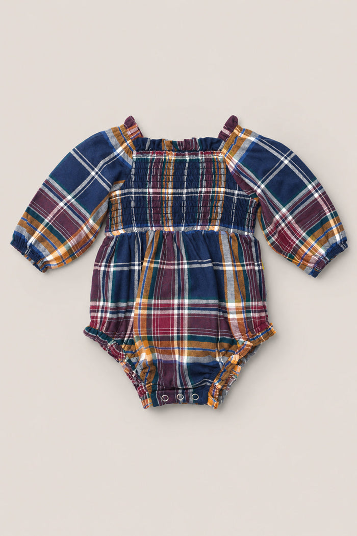 The Baby Madeline Romper in Midnight Plaid by Ivy City Co features a charming plaid design with a smocked bodice, puff sleeves, elastic cuffs, and convenient snap closures at the bottom. Available in navy blue, burgundy, yellow, and white.