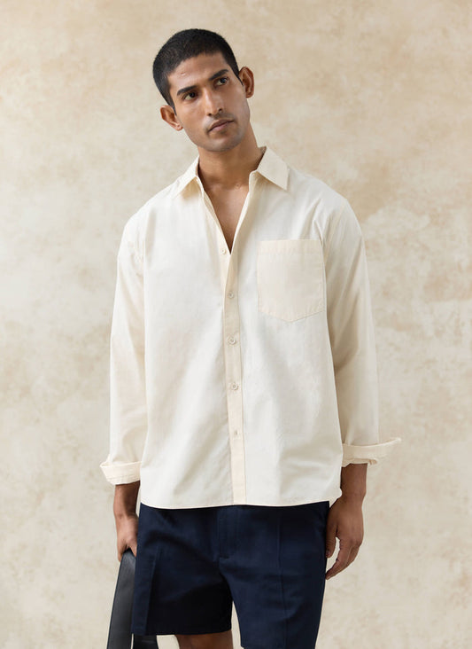 Percival Dali Relaxed Poplin Shirt in cream cotton with a point collar and chest pocket, worn by a model.