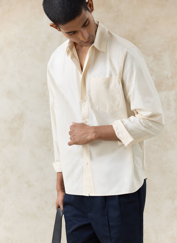 Percival Dali Relaxed Poplin Shirt in cream cotton, styled on a model with rolled sleeves and a chest pocket detail.
