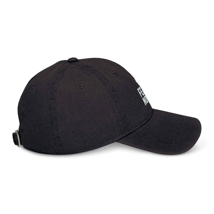 Adjustable denim cap shown on a model outside, featuring Fear None embroidery at the front and a relaxed six-panel cap shape.