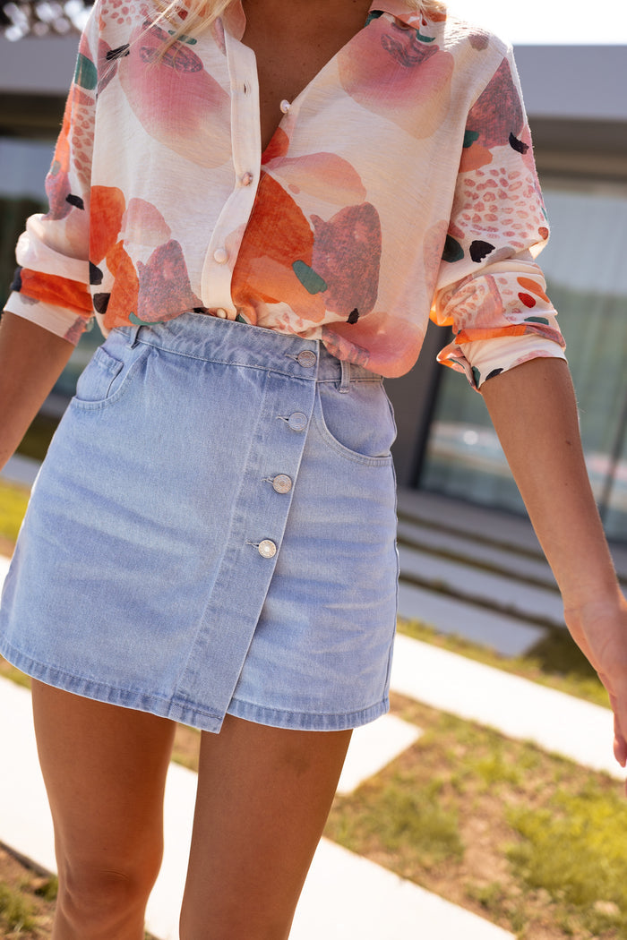 Light wash denim Lilia skort with wrap-front button placket, front view
