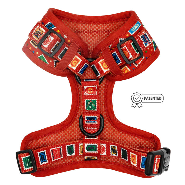 The Sassy Woof Dog Adjustable Harness - Harry Potter™ Stamps features red mesh, colorful stamp-inspired trim, black buckles, a metal D-ring, and a patented icon—perfect for wizarding world fans.