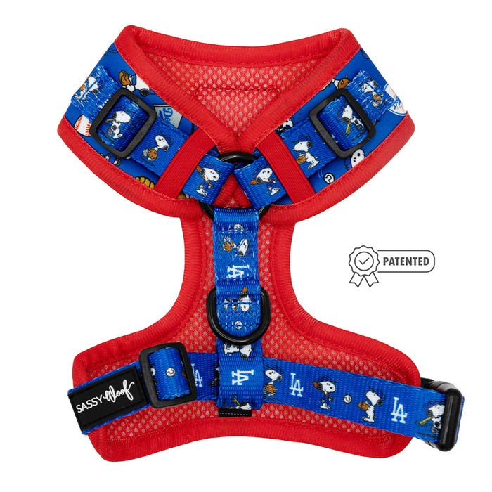 The Sassy Woof Dog Adjustable Harness - MLB™ x Peanuts™ Los Angeles Dodgers™ features red and blue straps, Peanuts characters, official team logos, adjustable buckles, a Sassy Woof label, and a patented design—perfect for Dodgers fans.
