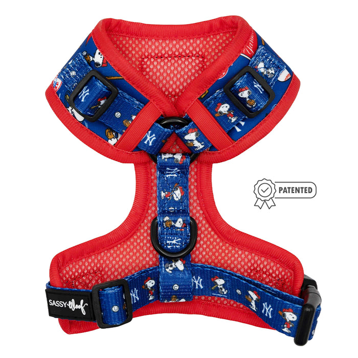 The Dog Adjustable Harness - MLB™ x Peanuts™ New York Yankees™ by Sassy Woof features red and blue mesh, adjustable straps, team logo, Peanuts dog cartoons, a patented icon, and offers comfort and protection for growing puppies.