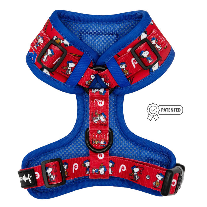 The Sassy Woof Dog Adjustable Harness from the MLB™ x Peanuts™ Philadelphia Phillies™ collection features red and blue mesh, a Snoopy and Peanuts character print, black adjustable buckles, and a patented badge icon.