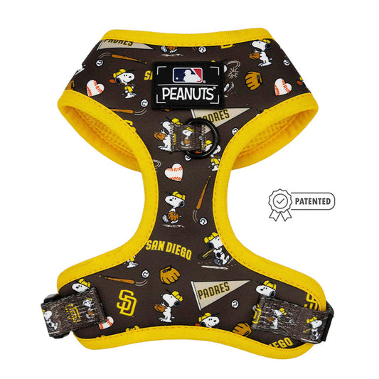The Sassy Woof Dog Adjustable Harness—MLB™ x Peanuts™ San Diego Padres™ features brown and yellow colors, Peanuts characters, baseball graphics, an MLB Peanuts logo patch, and a patented badge—designed for adjustable puppy growth protection.