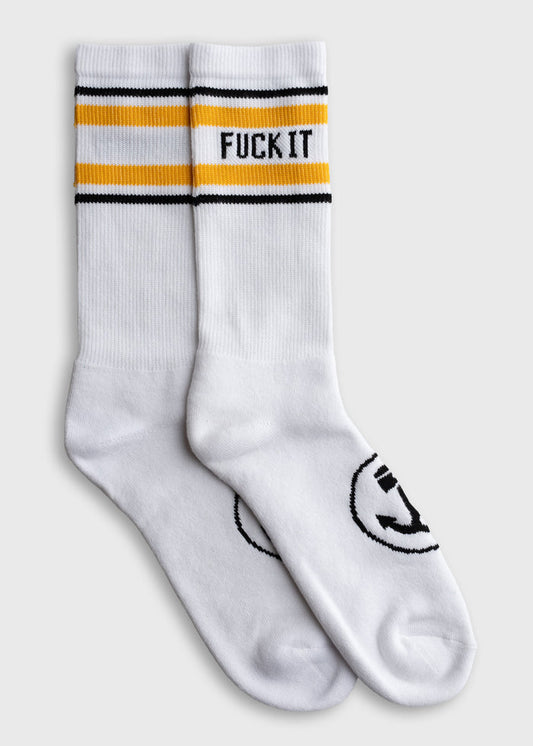 White socks with yellow and black stripes, featuring bold text "FUCK IT" on the top. Simple, casual design.