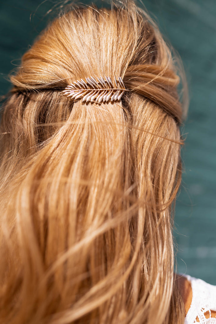 Golden Cannes feather hairclip close-up