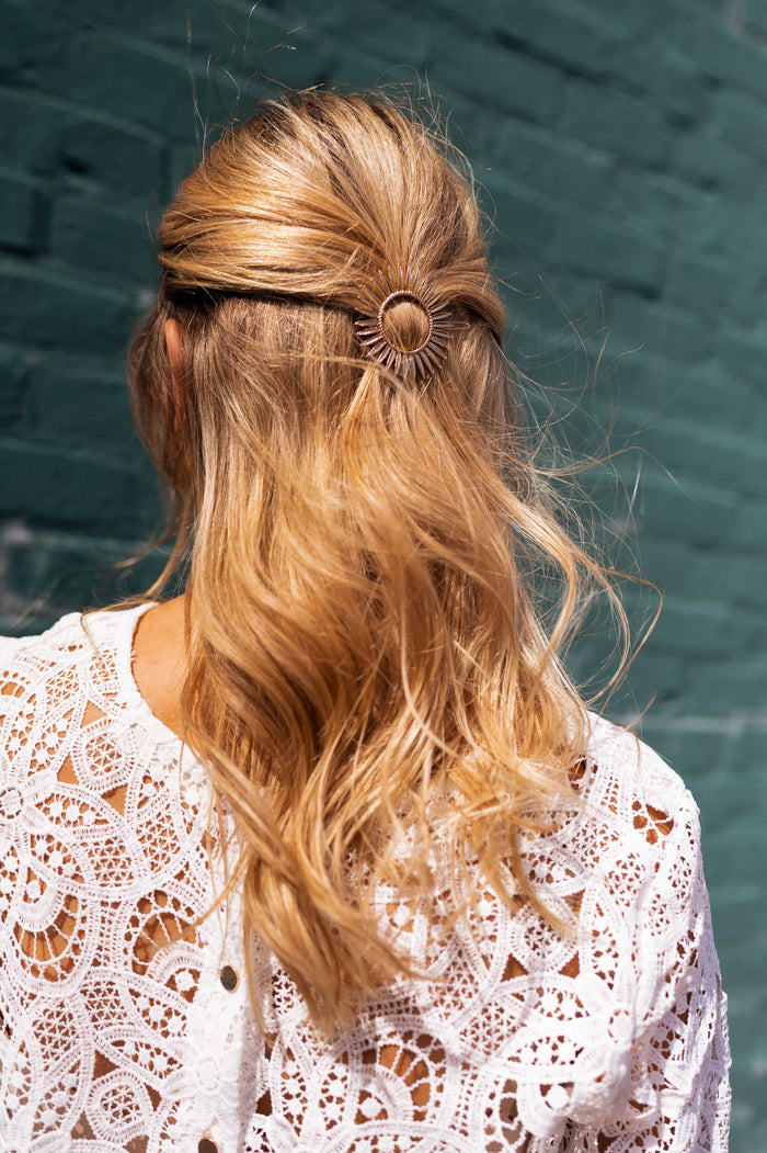 Golden Sola sunburst hairclip worn in hair