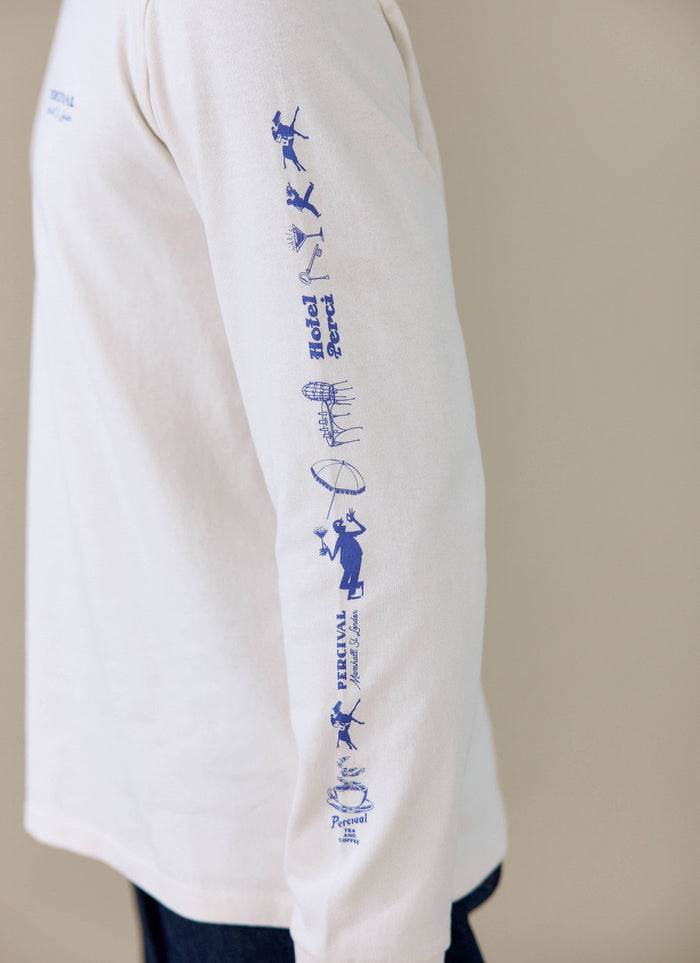 Close-up of the blue graphic print on the sleeve of the Percival Harlow Fine Wines long sleeve T-shirt in cream.