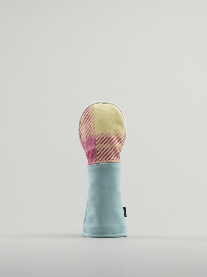 Golf club headcover made of pink and yellow plaid with a blue leather base.