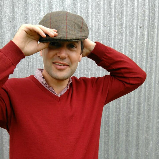Man wearing olive coloured Bingley Check Lambswool Tweed Cheesecutter hat.