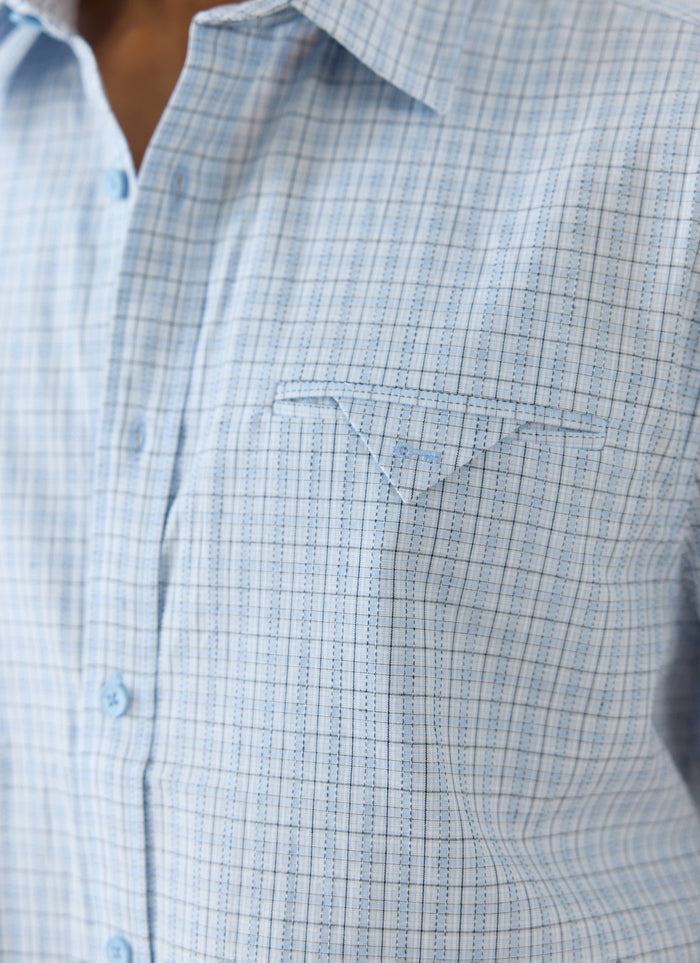 The Percival Hinsley shirt in blue check cotton, featuring a boxy fit and distinctive pocket detail with embroidered key.