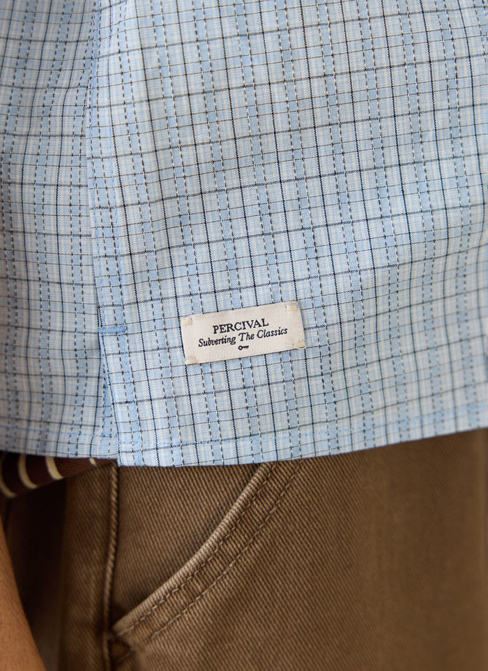 Percival Hinsley blue check cotton shirt close-up with embroidered key label, styled with Lucas carpenter pants.