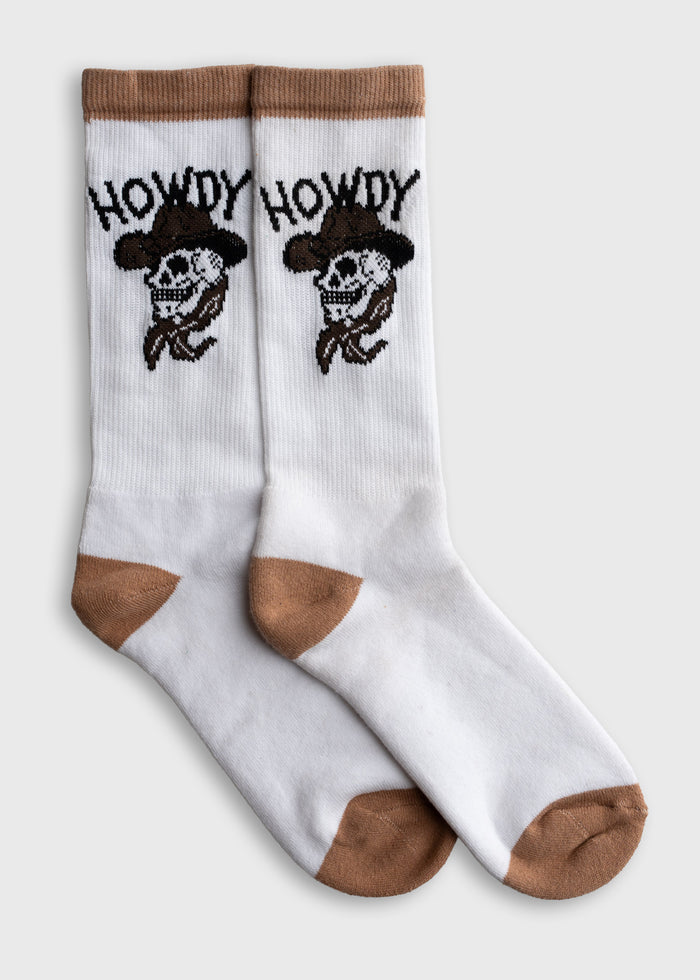 White socks with brown accents feature a cowboy skull and "Howdy" text, blending Western style with playful design.
