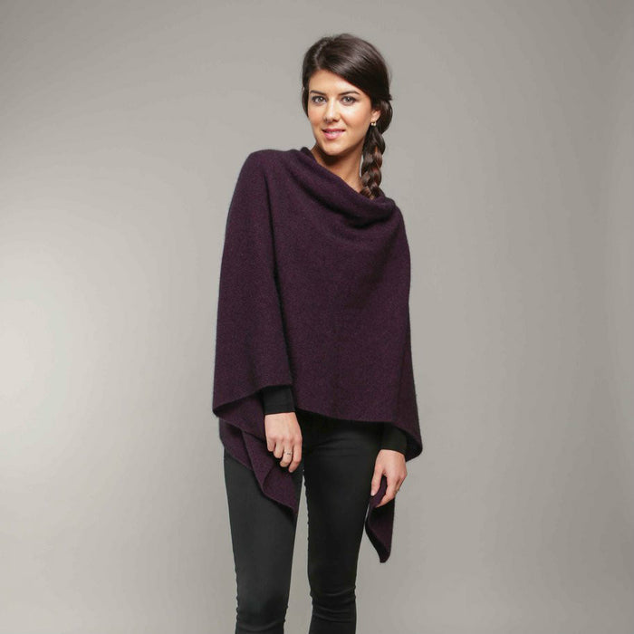 A woman wearing a grape-coloured Koru merino and possum Two Way Poncho.