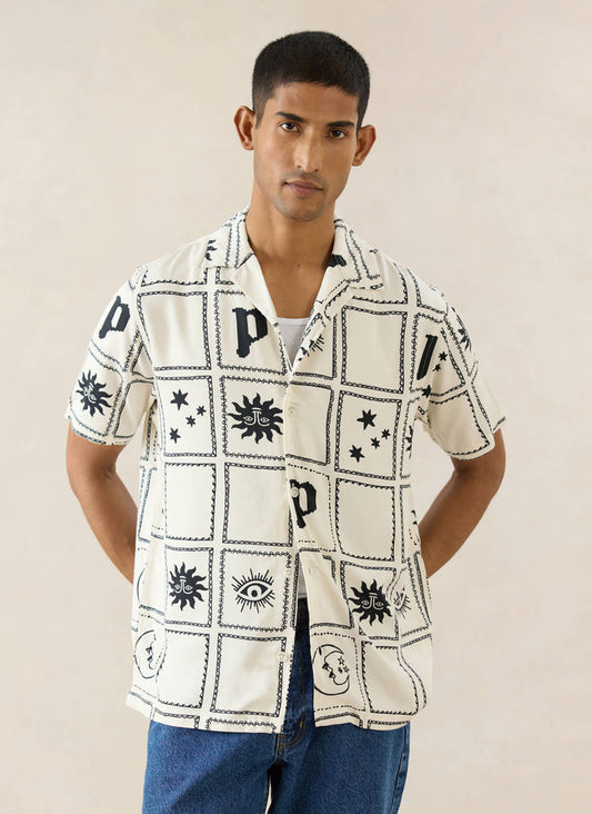 Percival Lunar Panel Cuban Shirt in cream viscose, featuring black celestial graphic panels, worn by a model.