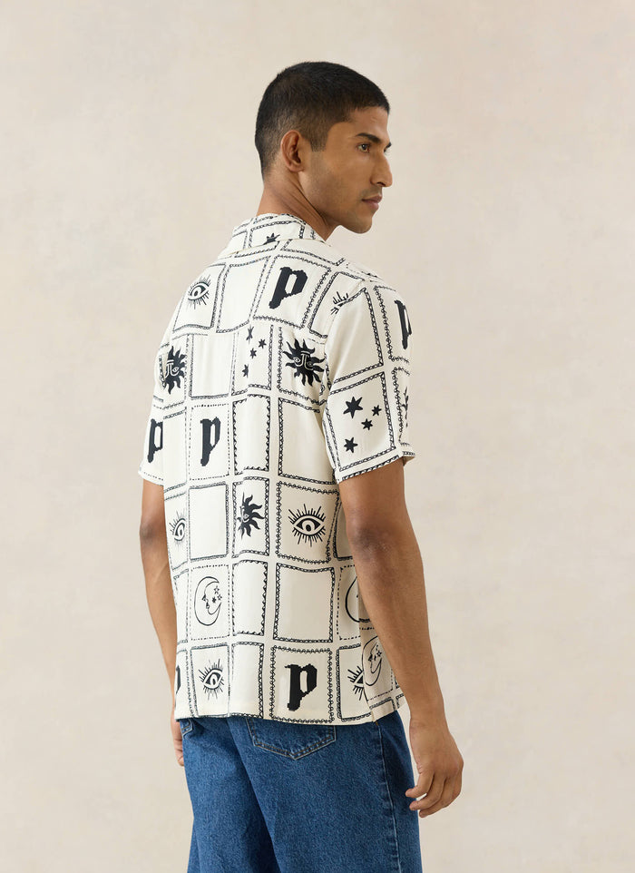 The Percival Lunar Panel Cuban Shirt in cream viscose, featuring black celestial graphics, viewed from the back on a model.