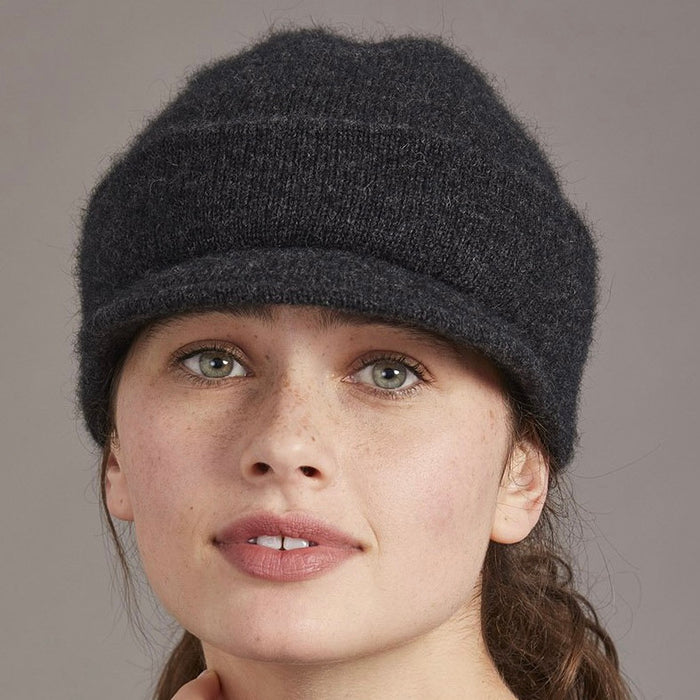 Woman wearing merino and possum cap with peak in charcoal