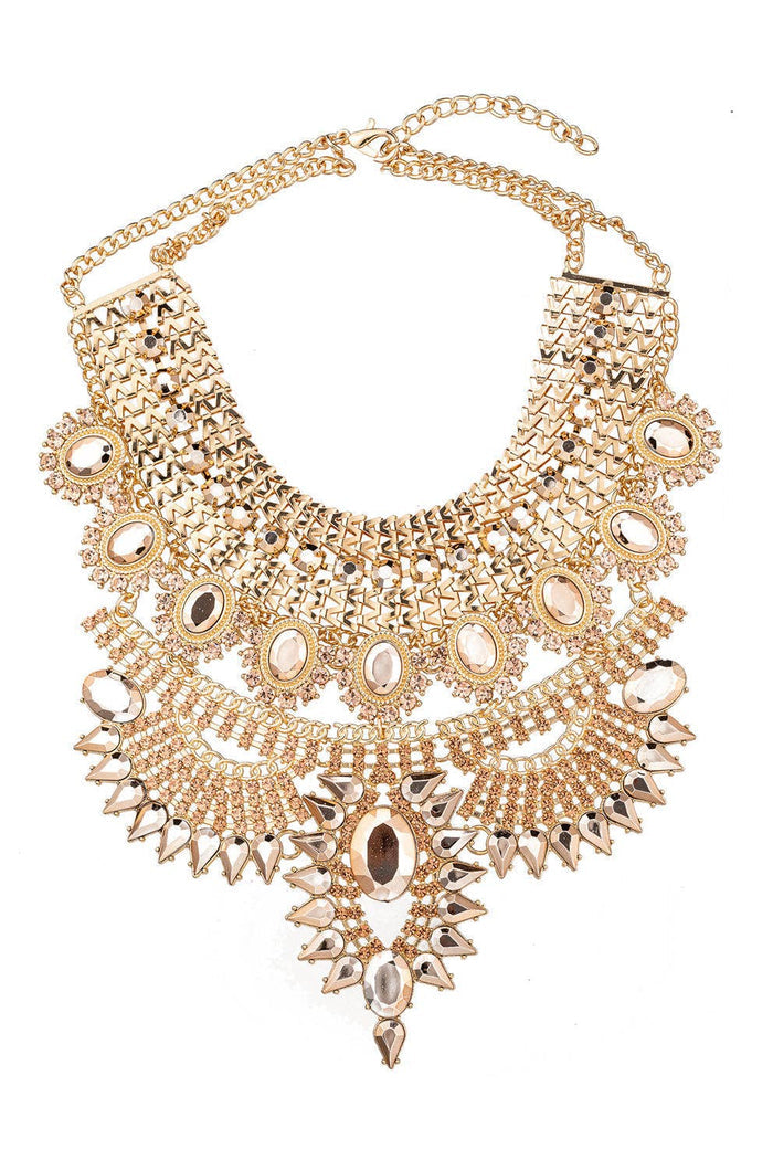 Metallic gold wide bib collar necklace with layered detail and crystal embellishments.