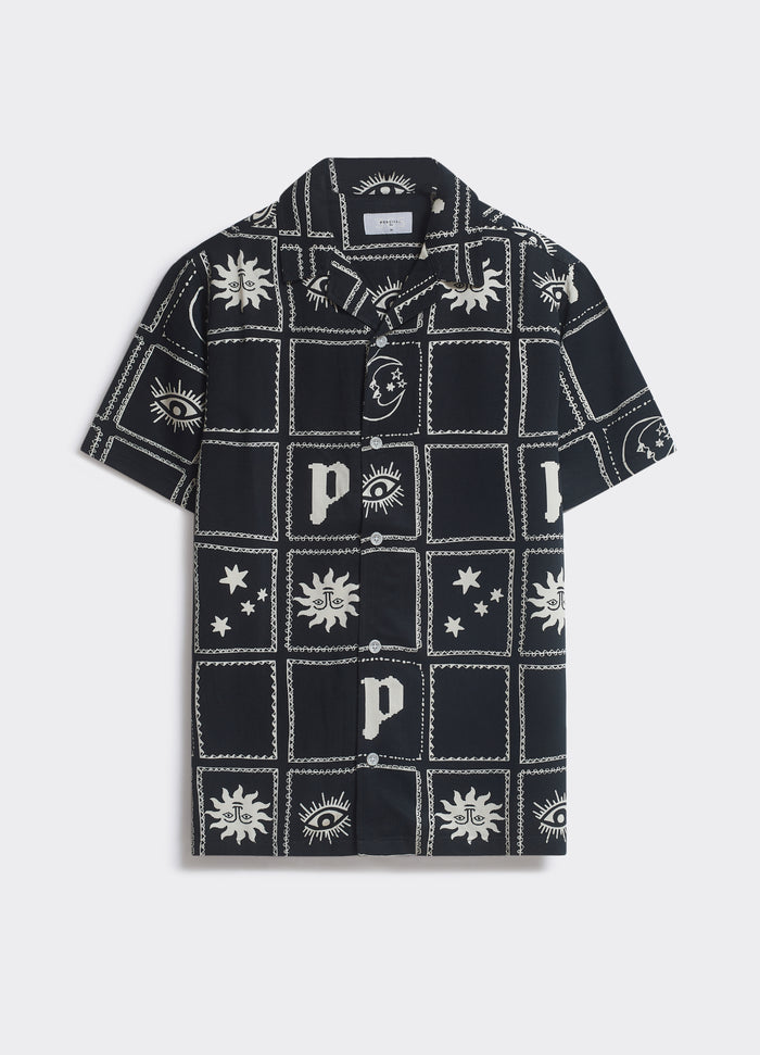 The black Percival Panels Shirt featuring ecru celestial artwork and a Cuban collar, shown flat on a light background.