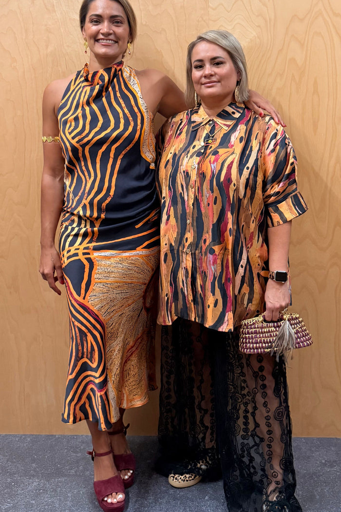 Two Aboriginal women in First Nations designed clothing