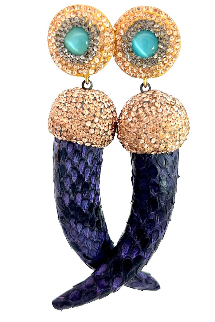 Purple leather horn dangle earring with crystal embellishment and a turquoise cabochon accent.