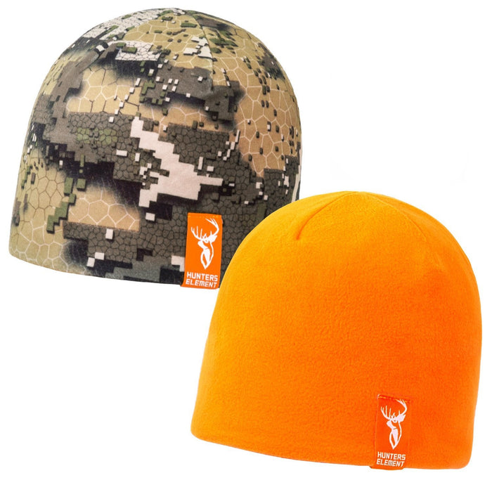 A reversible beanie with one side showing a digital camouflage pattern and the other side solid orange. The hat features a logo on the bottom cuff.