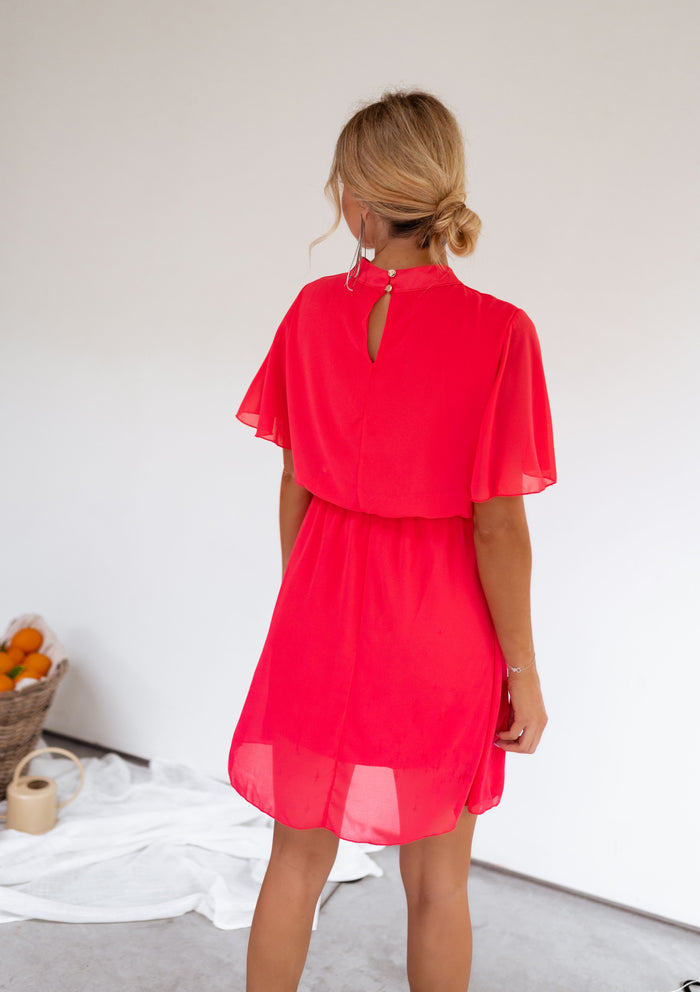 Raspberry Amandine dress showing flared cape sleeves
