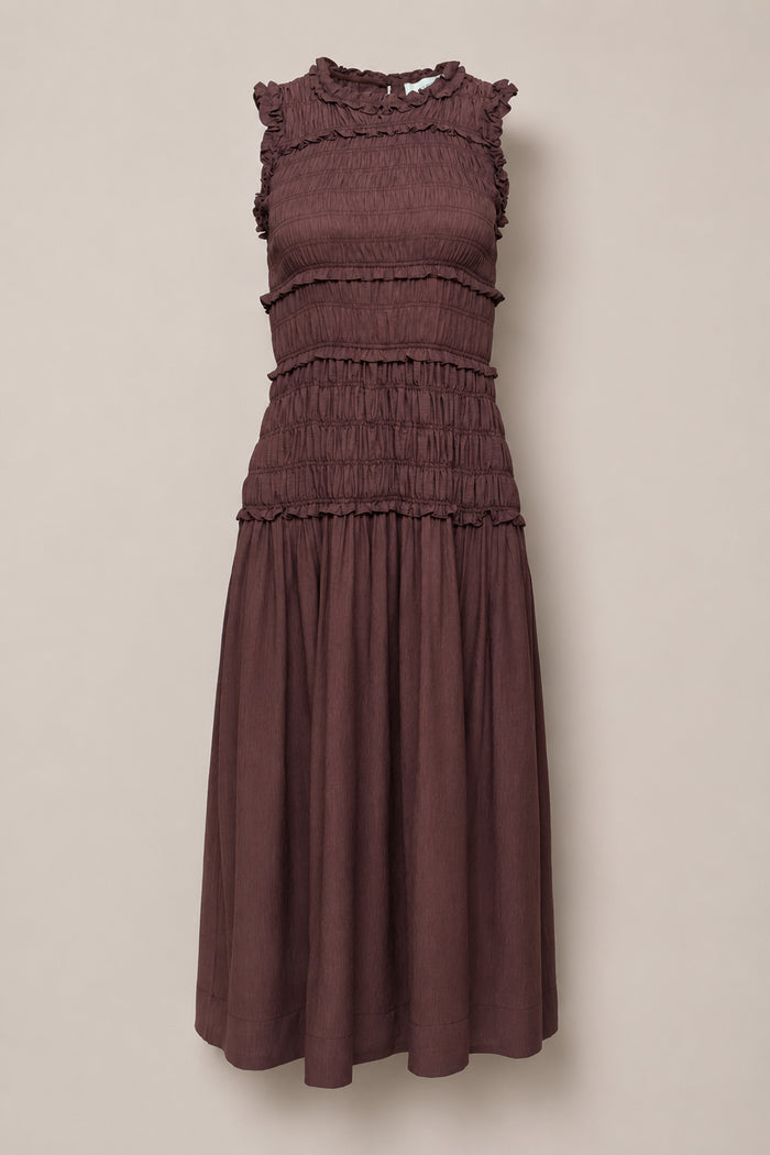 Sleeveless, knee-length Simone Dress in Warm Cocoa by Ivy City Co, featuring a smocked bodice, ruffled neckline and shoulders, and a gathered skirt—maternity friendly and displayed against a plain light background.