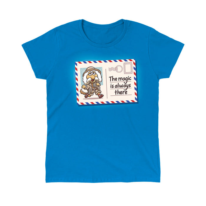 Classic Cotton T-shirt_TeeTurtle sapphire blue The Magic Is Always There apparel featuring Uncle Traveling Matt on a mail postcard with the caption on the underneath the stamp, “The Magic Is Always There“.