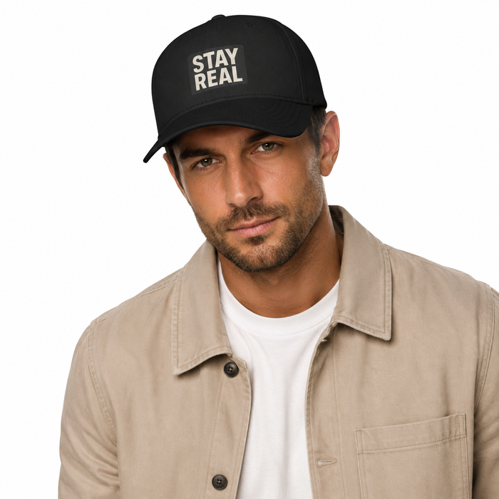 Black adjustable unisex baseball cap with minimalist Stay Real slogan