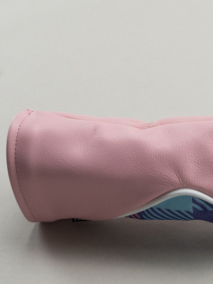 Pink golf club head cover with a pink yellow and blue plaid window