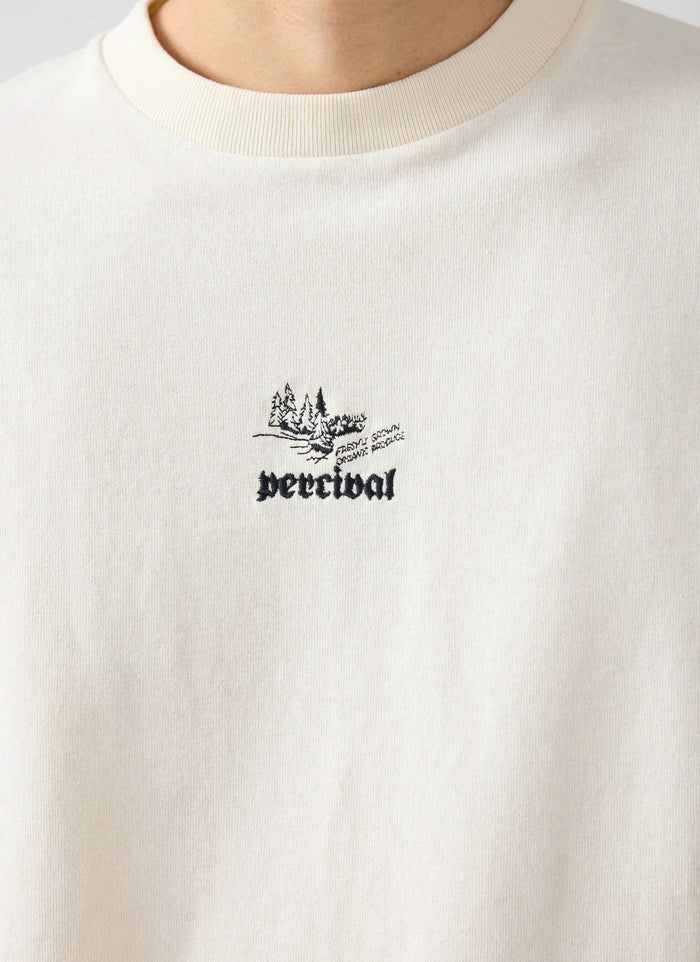 A close-up of the embroidered chest graphic on the Percival Wildlands Oversized T Shirt in ecru.