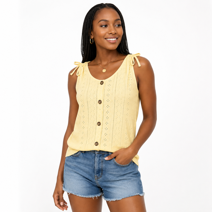 Women's yellow eyelet tank top with button detail and shoulder ties on model